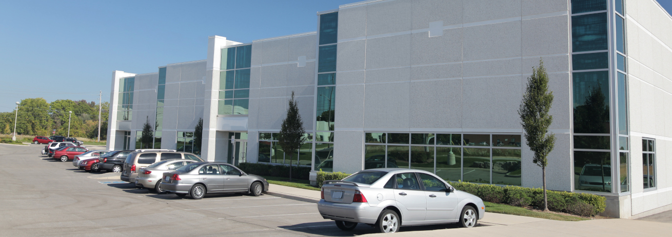 Building with cars parked.